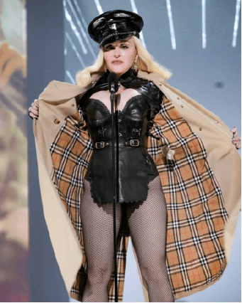 Madonna with police cap and beriberi rain coat having her performance